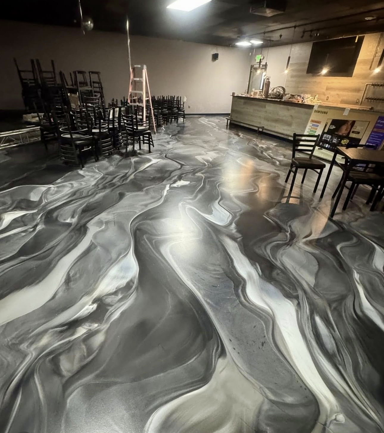 Metallic epoxy floor with deep blue tones and hexagonal design